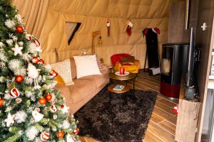 a living room with a christmas tree in a tent at Agros Glamping Boutique in Agros