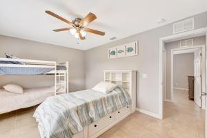 a bedroom with two bunk beds and a ceiling fan at Englewood Relaxation in Englewood