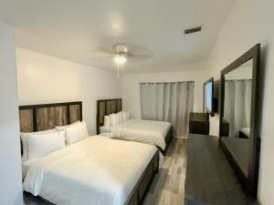 een slaapkamer met 2 bedden en een spiegel bij Designer House 3 Bed King Bed Close to South Beach in Miami
