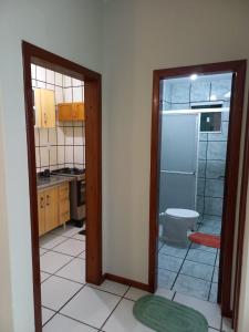 a kitchen with a bathroom with a shower and a toilet at Apartamento Balneário Piçarras in Piçarras