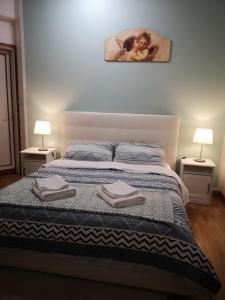 a bedroom with a large bed with two night stands at Firenze inn 21 Florence in Florence