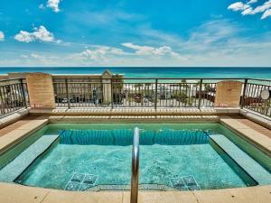 a swimming pool with the ocean in the background at Origin at Seahaven in Panama City Beach