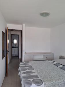 a bedroom with a large bed and a kitchen at Bangalô/Dúplex Jacumã Conde in Jacumã +17 photos