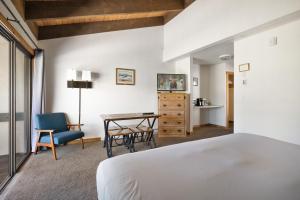 Schlafzimmer mit einem Bett, einem Tisch und Stühlen in der Unterkunft Elk Refuge Inn in Jackson