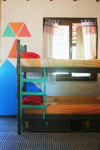 a bunk bed with two bunk beds in a room at Praia do Rosa Hostel in Praia do Rosa