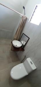 a bathroom with a toilet and a sink in a room at Hardin De Marbella in El Nido
