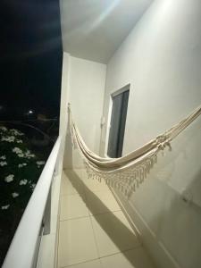 a hammock on the side of a building at night at FLATS VALLE DEL SOL in Japaratinga