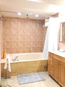 y baño con bañera y lavamanos. en Large Suite Fairfield Heritage Manor, Free Parking, en Victoria