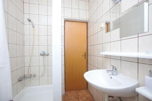 a bathroom with a sink and a toilet and a shower at Apartments with a parking space Pirovac, Sibenik - 15320 in Pirovac