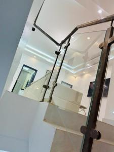 a glass staircase in a house with a mirror at VILLA NAYFAL in Saly Portudal