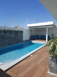 a swimming pool in the backyard of a house at VILLA NAYFAL in Saly Portudal