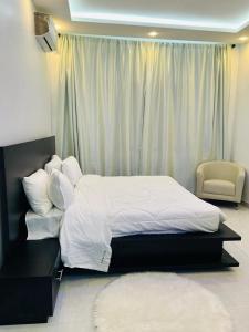 a bedroom with a large bed with white sheets and pillows at VILLA NAYFAL in Saly Portudal +74 photos