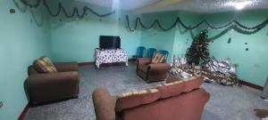 a living room with couches and a christmas tree at Casa Julia Xela in Quetzaltenango