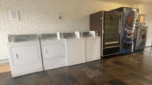 a room with three washing machines and a refrigerator at Motel 6-Sallisaw, OK in Sallisaw