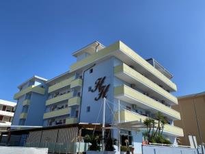 a building with a sign on the side of it at Hotel Holiday in Martinsicuro