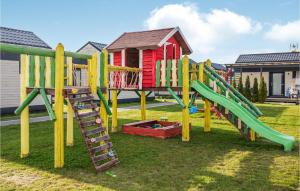 a playground with a slide in the grass at Nice Apartment In Jezierzany With Kitchen in Jezierzany