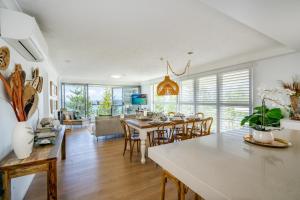 a kitchen and dining room with a table and chairs at Cashelmara Beachfront Apartments in Gold Coast
