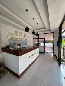 a restaurant with a counter in the middle of a room at Jasmine Vangvieng Hotel in Vang Vieng +37 photos
