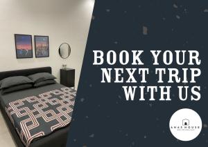 a bedroom with a bed and a sign that reads book your next trip with us at Anas House in Tanjung Rambutan