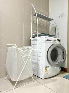 a washing machine sitting next to a washer at KL Gateway Residency in Kuala Lumpur