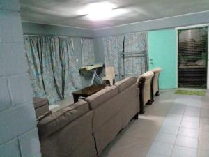 a waiting room with a row of seats in a room at Green Lodge Holiday Homes in Nuku‘alofa