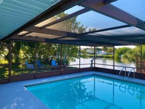 a swimming pool with a view of a river at Blue Heron House, Private 4 BR Waterfront w Heated Pool and Fire Pit in Ruskin