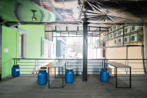 a room with two tables and benches in a building at RedDoorz near Flyover Arjosari Malang in Malang