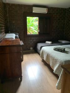 a room with two beds and a window in it at Recanto das Águias - Caminhos de Caravaggio in Nova Petrópolis