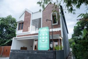 een huis met een bord ervoor bij Twin House near UII Yogyakarta Mitra RedDoorz in Yogyakarta