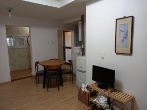 a living room with a table and a television at Jemulpo house - Foreigner Only in Incheon