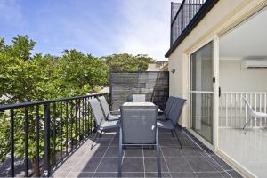 eine Terrasse mit Stühlen und einem Tisch auf dem Balkon in der Unterkunft Aqua Lagoon - Great Family Beach Getaway in Nelson Bay