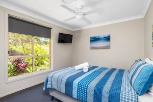 a bedroom with a bed and a window at Aqua Lagoon - Great Family Beach Getaway in Nelson Bay