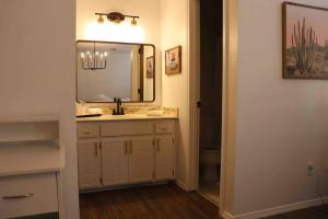 a bathroom with a sink and a mirror at By HWY, 3/2 , sleeps large group Palo Duro Fun in Amarillo