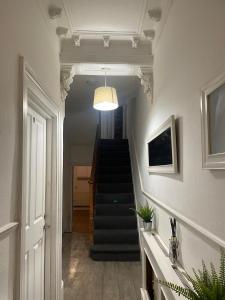 a hallway with a stairway with a stair case at Balham, South London Spacious Guest House 1 in London