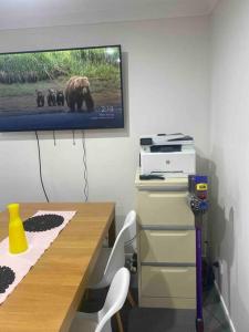 a room with a desk with a bear on the wall at Nearly new 2 bedrooms private entire unit in Slacks Creek