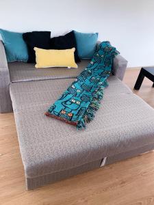 a couch with a scarf sitting on it at Increible Casa ideal Familias in Ushuaia