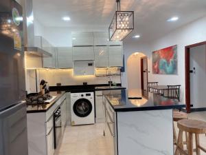 a kitchen with a washer and dryer in it at 3 Bedroom Villa Praitumnak soi 4 by Daisy Pattaya in Pattaya South +46 photos