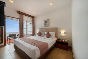 a bedroom with a bed with a view of the ocean at Sterling Yercaud in Yercaud