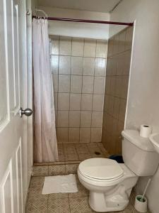 a bathroom with a toilet and a shower at Christina's Guest House OFFICIAL in Little Corn Island