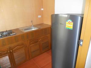 a stainless steel refrigerator in a kitchen with a sink at P and A Thai Lanna Resort in Chiang Mai