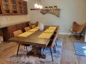 a dining room with a wooden table and chairs at Sky Lodge in Wrightwood