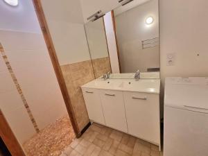a bathroom with a white sink and a mirror at Appartement Saint-Michel-de-Chaillol, 3 pièces, 10 personnes - FR-1-393-42 in Saint-Michel-de-Chaillol