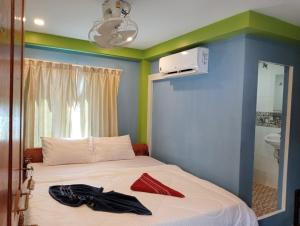 a room with a bed with a blue and green wall at Villa Koh Rong in Koh Rong Island