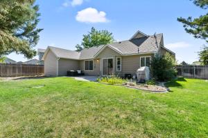 a home with a fence and a yard at Southwestern Style 4 Bedroom Nampa Home Sleeps 16! in Nampa