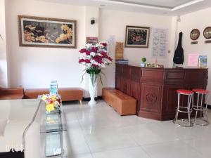 ein Wartezimmer mit einer Blumenvase an der Wand in der Unterkunft Kim Huong Quang Hotel in Phu Quoc
