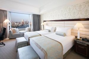 a hotel room with two beds and a view of the city at InterContinental Tokyo Bay by IHG in Tokyo