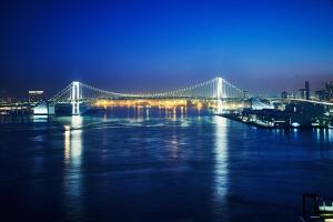 a large white bridge over the water at night at InterContinental Tokyo Bay, an IHG Hotel in Tokyo