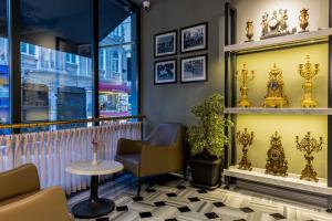 a waiting room with a chair and a table at Marius Hotel in Istanbul