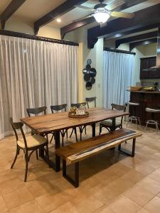 a dining room table and bench in a room at 3 Bedroom Villa in Hacienda Pinilla in Tamarindo