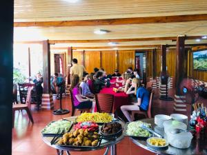a group of people sitting at a table with food at Duong Cong Chich Homestay in Lạng Sơn